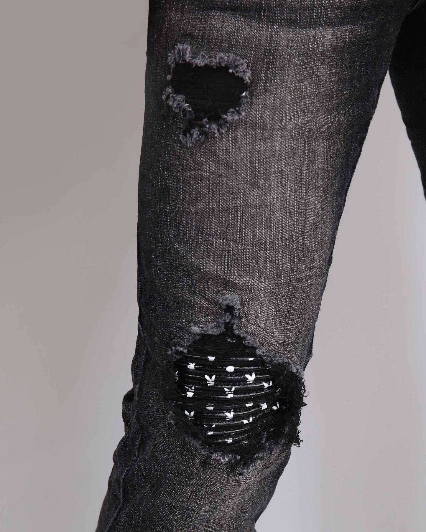 Black Ripped Jeans with Striking Black Patches