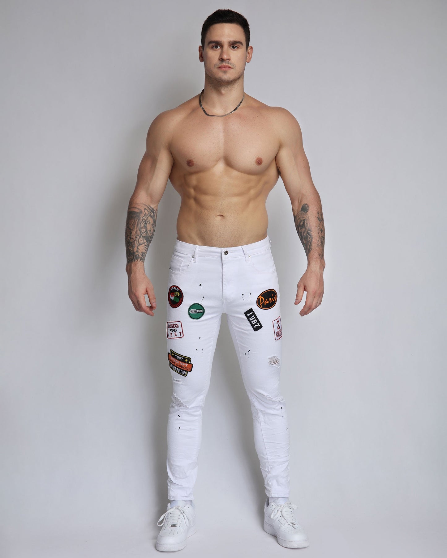 White Ripped Jeans with Badge and Black Spray Paint